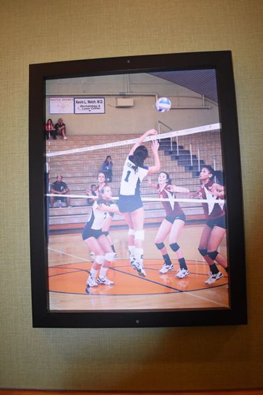 Pensacola State College volleyball game featuring players jumping for the ball in gymnasium.