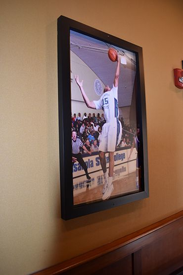 High school basketball player dunking during game at Pensacola State College.