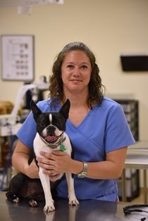 Vet Tech student holding a dog during dog wash event at Pensacola State College.