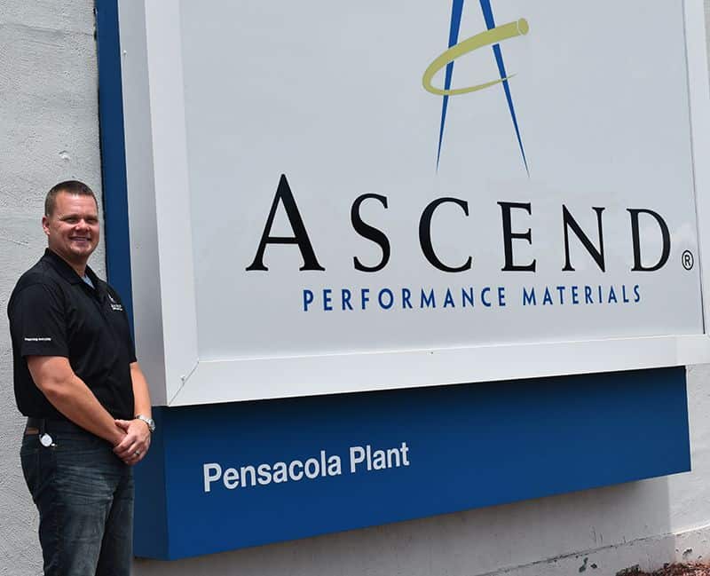 Manufacturing technician standing next to Ascend Performance Materials sign at Pensacola Plant.