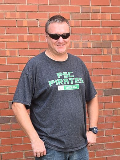 Cybersecurity student at Pensacola State College showing gratitude, wearing sunglasses and casual at.