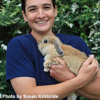 Veterinary Technology graduate with a rabbit, showcasing animal care skills at Pensacola State Colle.