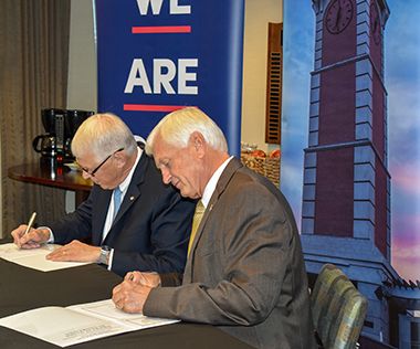 Pensacola State and University of South Alabama officials sign articulation agreement.