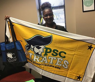 High-achieving student celebrating victory at Pensacola State College event.