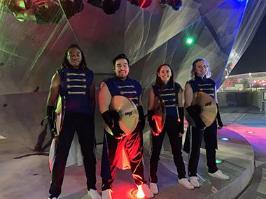 Pensacola State student plays cymbals during Super Bowl LIII halftime performance, showcasing music.