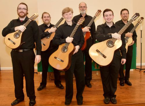 Guitar ensemble performing at Pensacola State College spring recital on March 30, showcasing talente.
