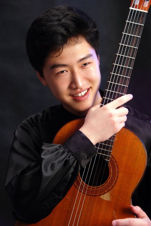 Guitarist Tengyue Zhang with classical guitar at PSC event.