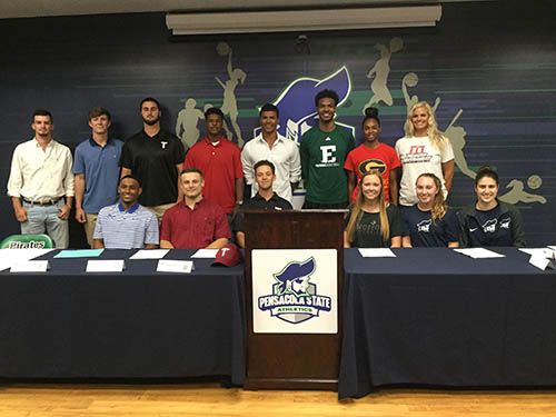 Student-athletes signing with universities at Pensacola State College for collegiate sports.