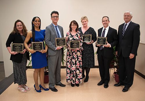 Inductees receiving awards for teaching excellence and academic achievement.