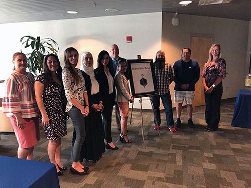 Inducted Pensacola State College students into Sigma Beta Delta honor society for academic excellenc.