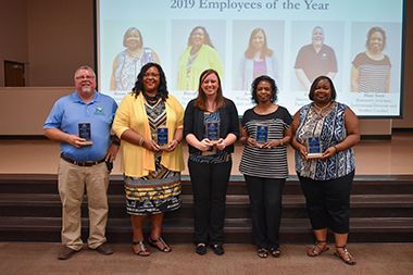 Group of Pensacola State Employees of the Year 2019 holding awards at recognition event.
