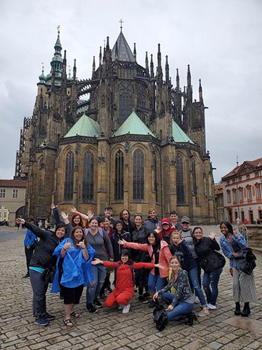 Diverse group of students visiting historic Central European landmarks during study abroad trip.