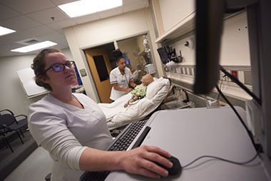 Nursing students engaged in hands-on patient care training at Pensacola State College.