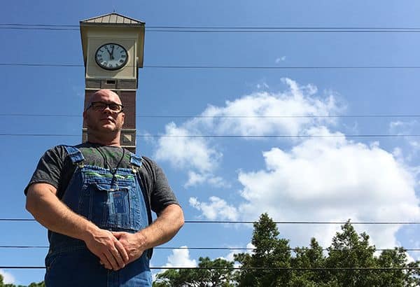 Food industry expert pursuing GED at PSC with clock tower background.