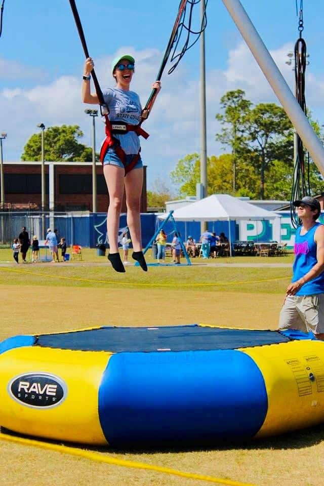 Outdoor student activities at Pensacola State College featuring trampoline fun.