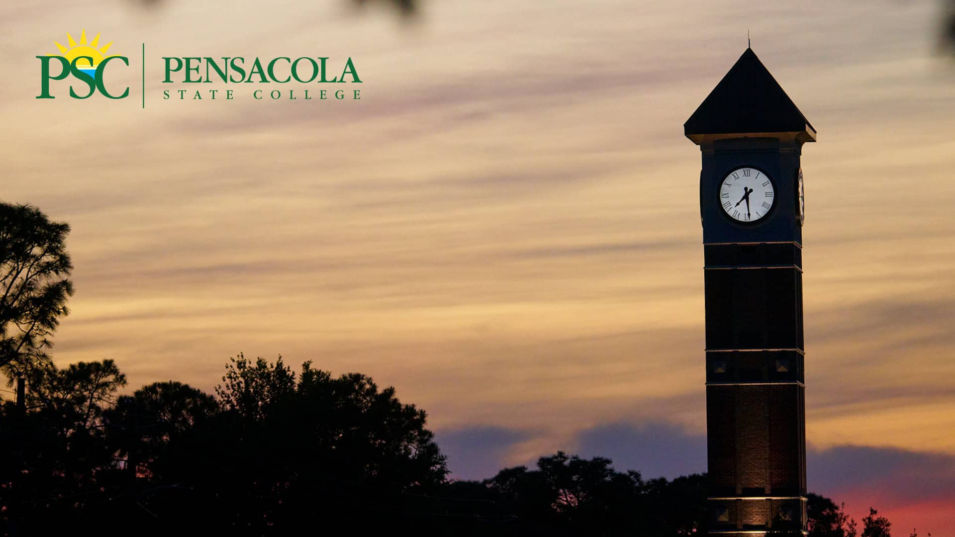 Clock tower at Pensacola State College showcasing branding during sunset.