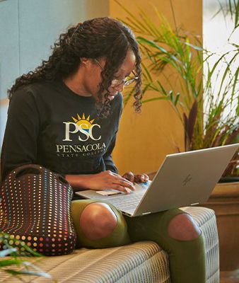 Student studying on laptop during summer session at Pensacola State College.