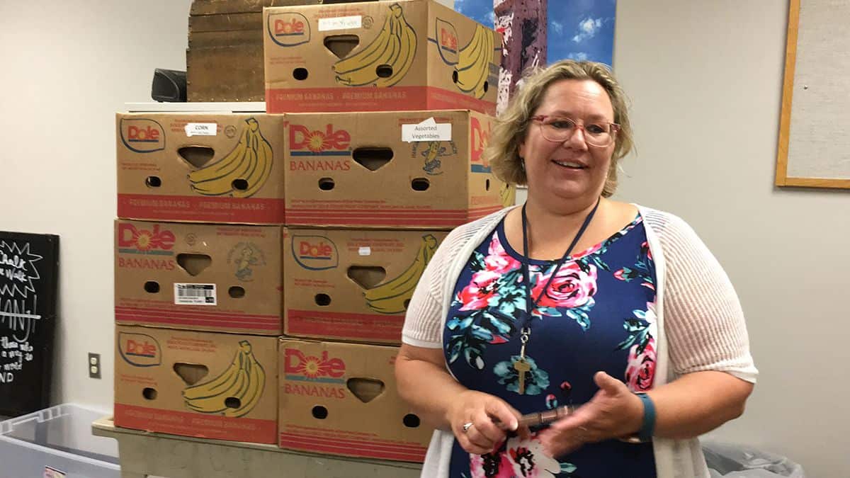 Food pantry restocking at Pensacola State College following AFC Food Drive donation.