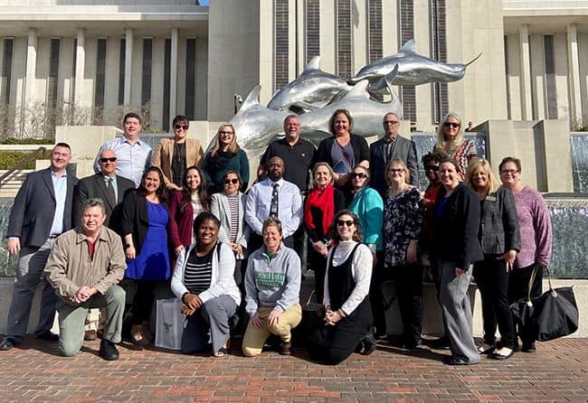 Diverse group of professionals gathered outdoors for President&rsquo;s Leadership Institute event at Pensa.