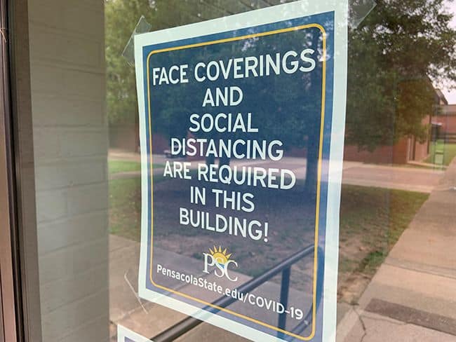 Face coverings and social distancing are required in college buildings.