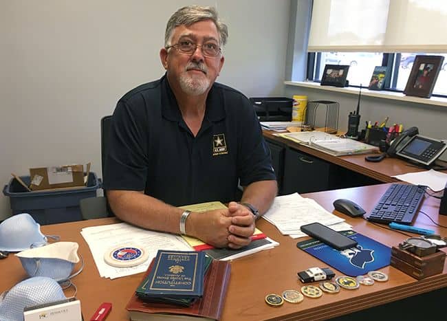 Experienced college police chief and alumnus of Pensacola State College in a professional office set.