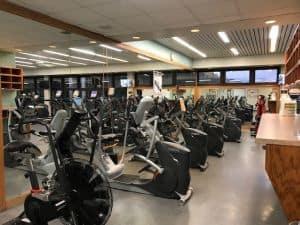 State-of-the-art cardio machines in a well-equipped college fitness center for student health.