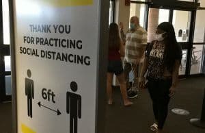 Social distancing reminder at Pensacola State College entrance.