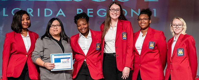 Highly skilled students celebrating SkillsUSA Florida Region 1 Alumni of the Year award at Pensacola.