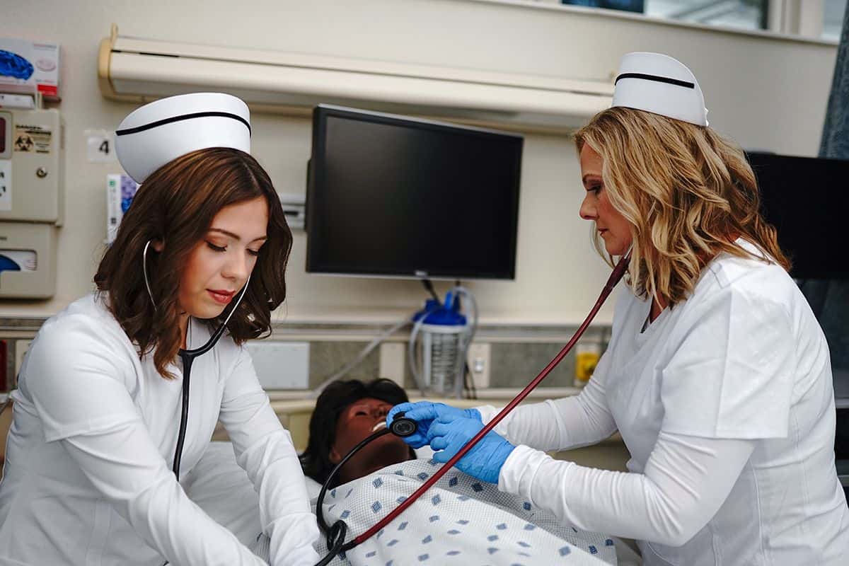 Nursing students providing patient care in a clinical simulation at Pensacola State College.