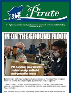 Pirate College students practicing carpentry skills on a ground floor construction project at Pensac.