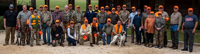 Alumni association's 2020 quail hunt and pheasant shoot with participants and hunting dogs.