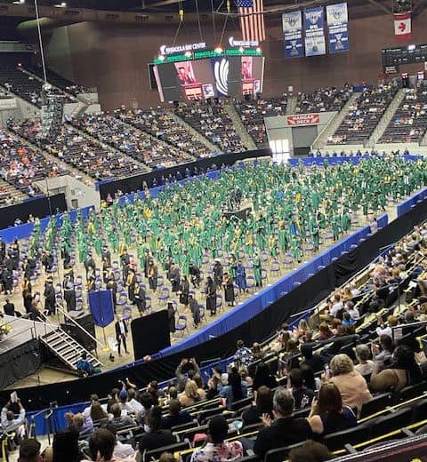 Pensacola State College graduation ceremony with students in caps and gowns.