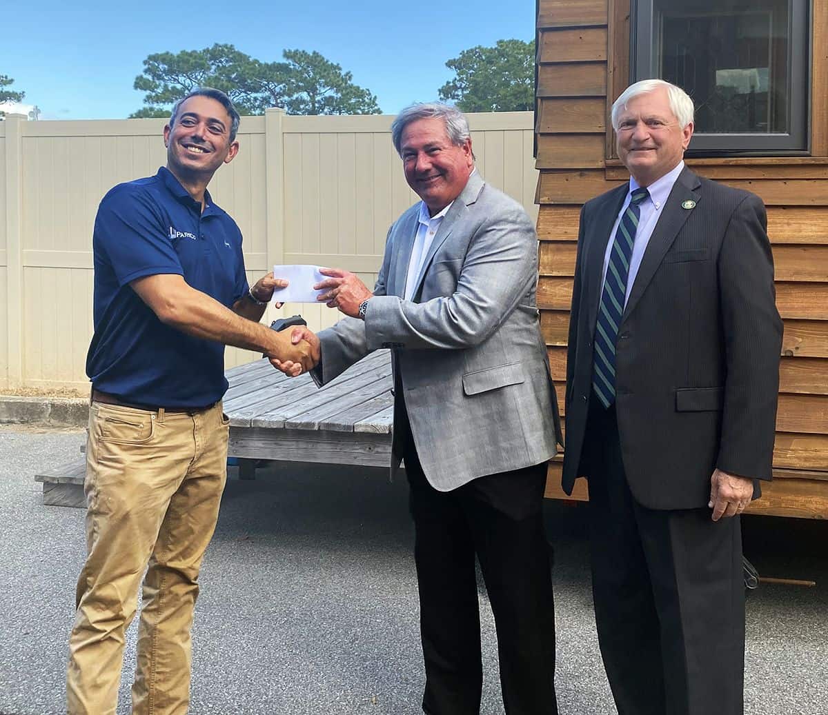 Scholarship presentation at Pensacola State College featuring local builder establishing Student Con.