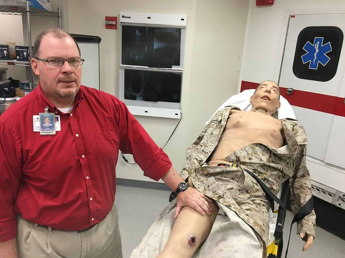 Realistic EMS training manikin at Pensacola State College designed to simulate injury and pain for s.