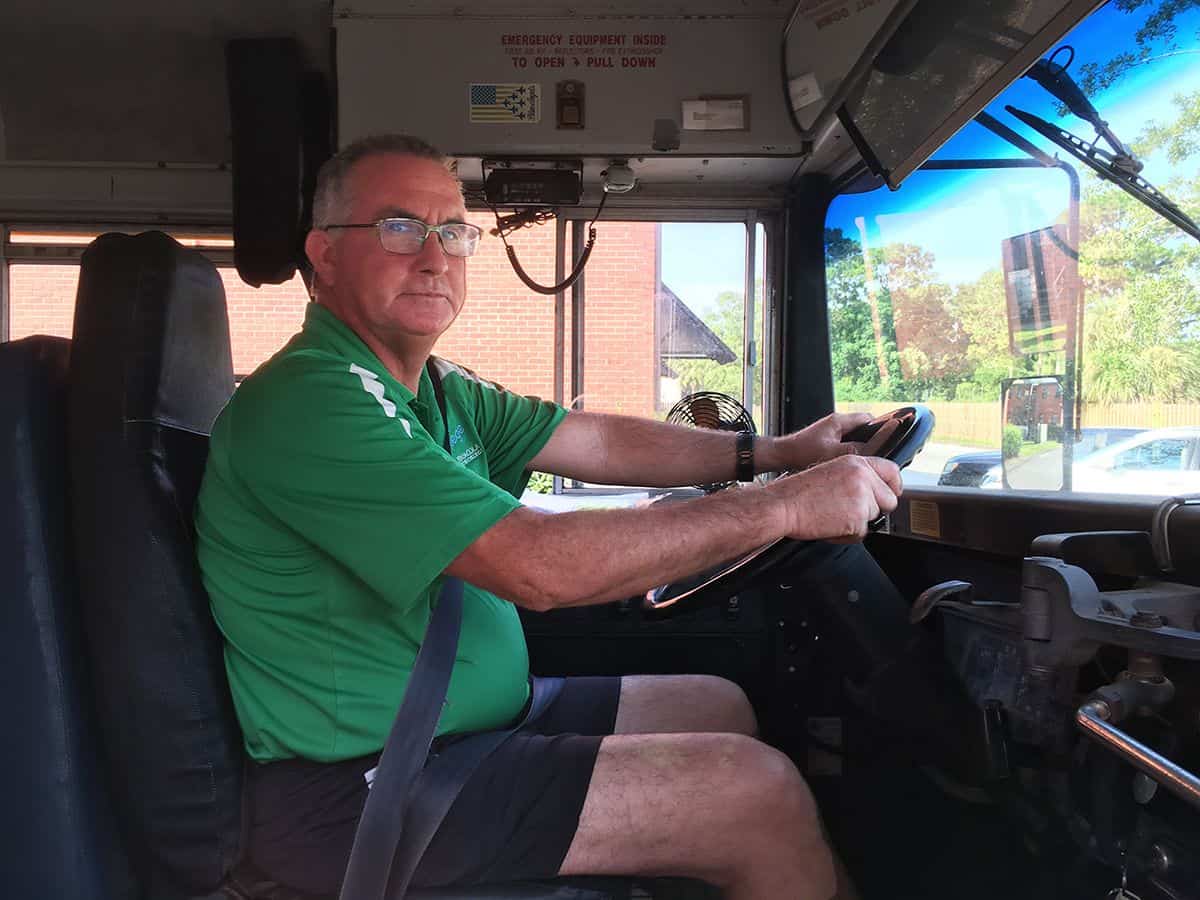School bus driver at Pensacola State College, symbolizing leadership transition in higher education.