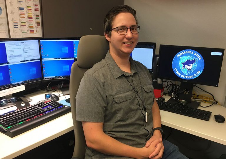 Ted Sumrall, cybersecurity club president, working as tech support specialist at Pensacola State Col.