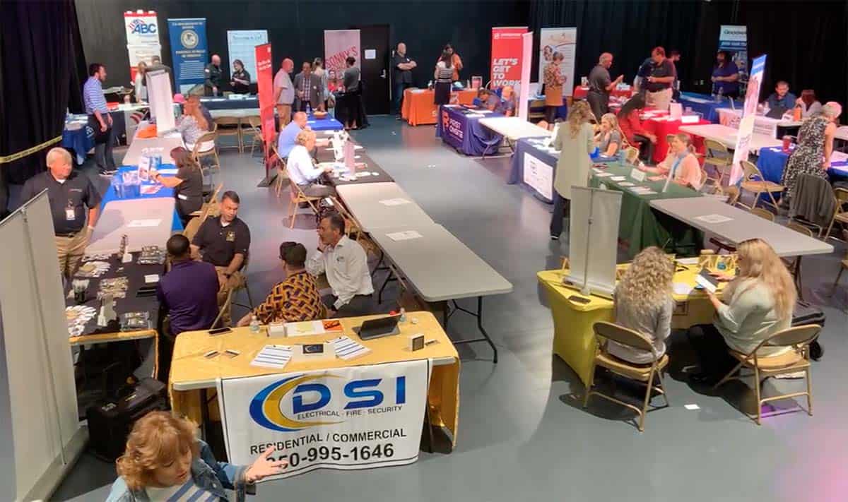 Job fair event at Pensacola State College featuring diverse employers and hundreds of jobseekers.