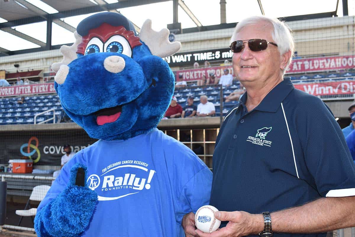 Blue Wahoos mascot and man at Pirate-themed event at Blue Wahoos Stadium, Pensacola State College celebration. Vibrant mascot and attendee enjoying Pirate party at Blue Wahoos Stadium, Pensacola State College ev.