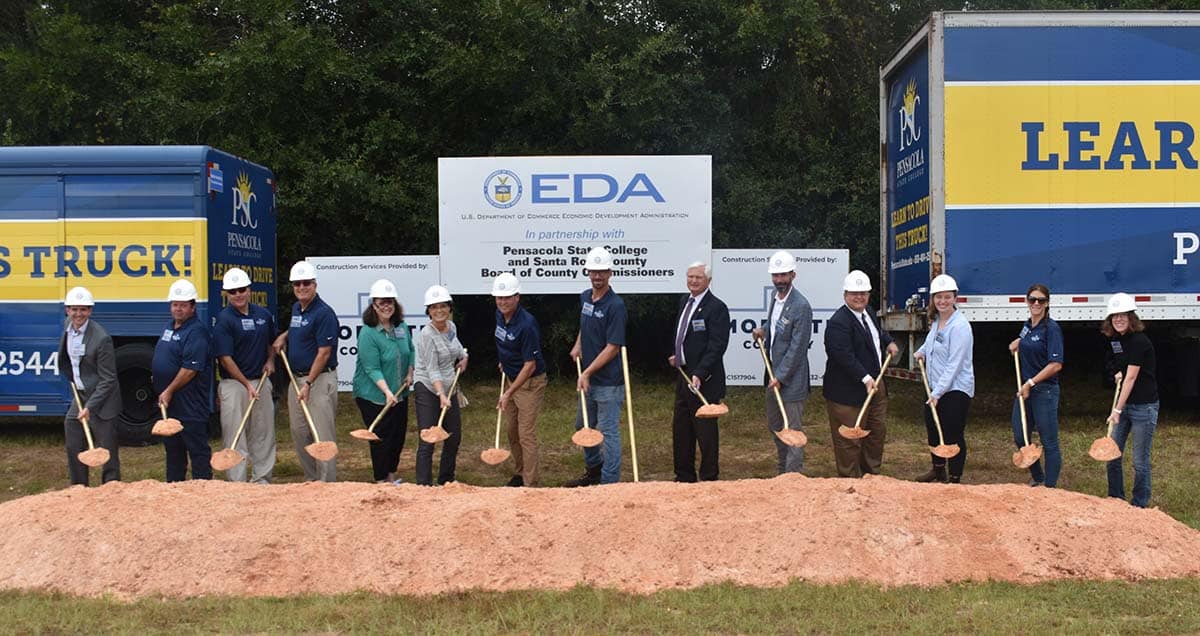 Pensacola State College groundbreaking for new truck driver training facility with students and offi.