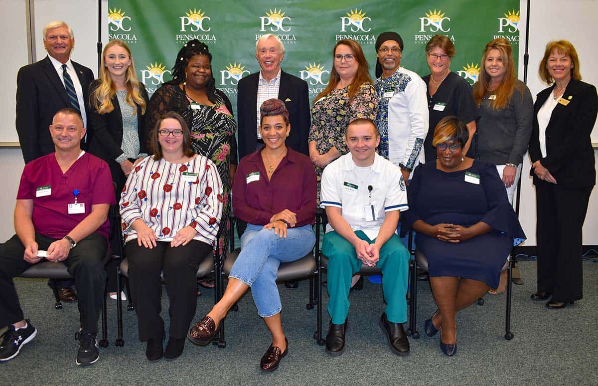 Diverse group of students and staff celebrating scholarship success and educational opportunities at.