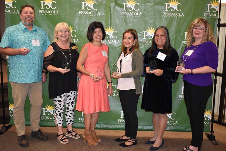 Highly accessible image of Pensacola State College staff receiving awards at the 2021 Employees of t.