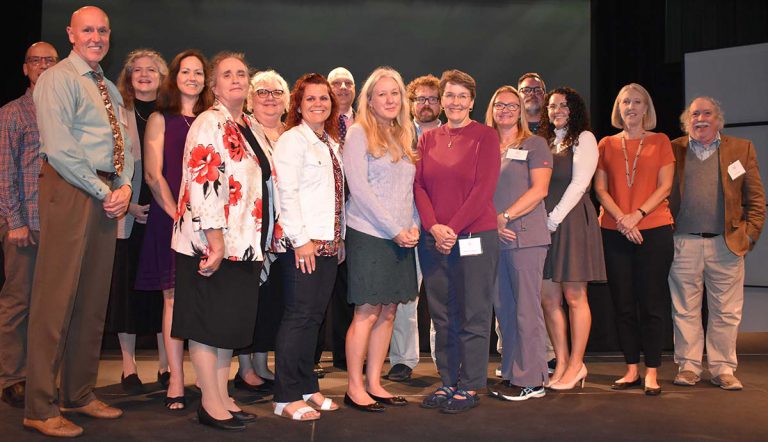 Group of staff members receiving service awards for institutional knowledge.