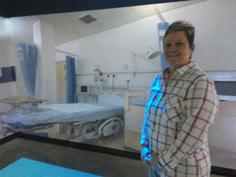 Student engaging with virtual healthcare simulation in PSC Health Sciences Department.