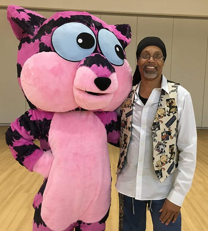 Dribbles the All-Knowing Cat mascot joins Troy Watts to promote engaging educational programs at PSC.