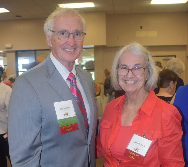 Dr. Troy Tippett and a female colleague at Pensacola State College during a formal event.