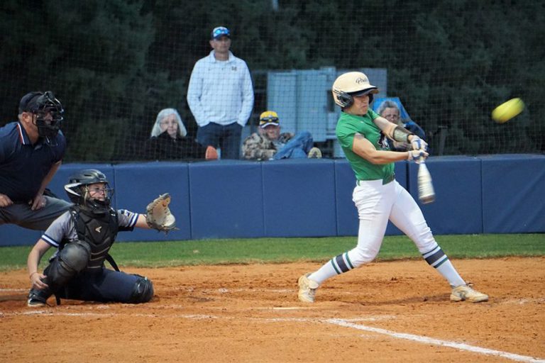 High school softball player batting during game at Pensacola State College.