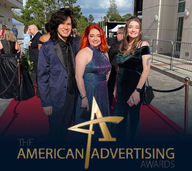 Three women at the awards ceremony celebrating PSC's advertising excellence.