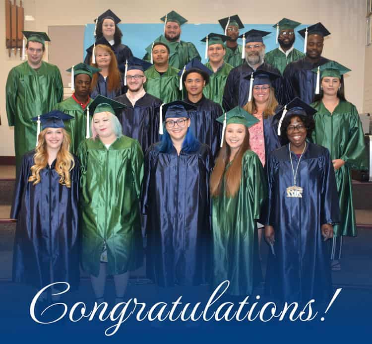 GED graduates in caps and gowns at Pensacola State College graduation ceremony.