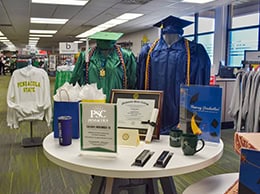 Graduation apparel, college merchandise, and textbooks available at Pensacola State College bookstor.
