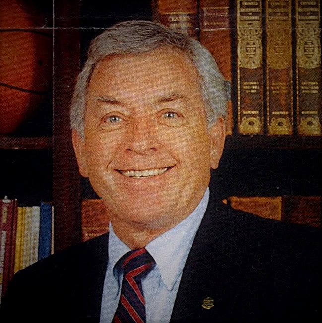 Horace &lsquo;Ed&rsquo; Hartsell, third president of Pensacola Junior College, in library with books.